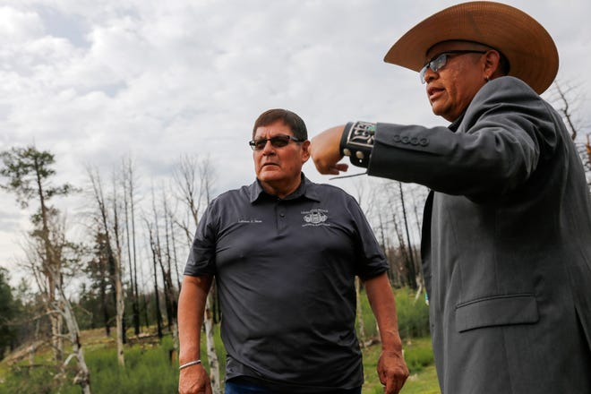 Navajo Nation Speaker LoRenzo Bates, left, talks with Navajo Nation Council Delegate Steven Begay Tuesday on Ch'ooshgai Mountain in the Naschitti Chapter.