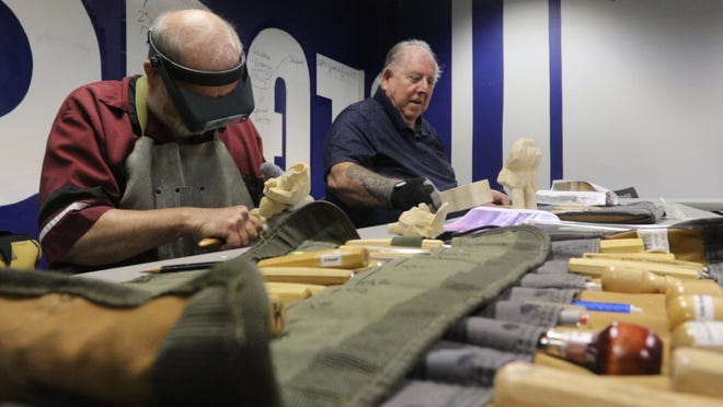 Al Krueger, left and Chuck Petrie carve wooden duck hunters in the event room at the IDEA Center in Stevens Point Monday, August 20, 2018. The two are part of the Wisconsin River Woodcarvers who meet twice a week at the center to carve. 