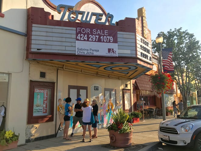 Community members chat outside the Tower Theater in downtown Santa Paula.