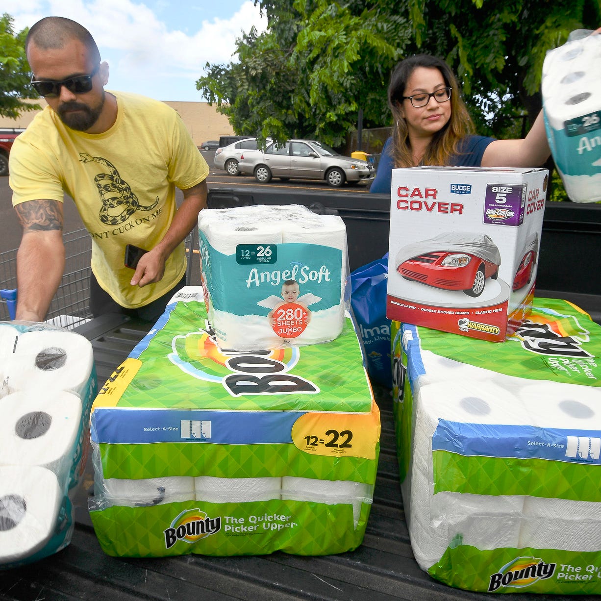 Bryce and Dom Boeder of Waimea, Kauai, load their truck with storm supplies in the parking lot of a Walmart store in Lihue, on the island of Kauai, Hawaii.