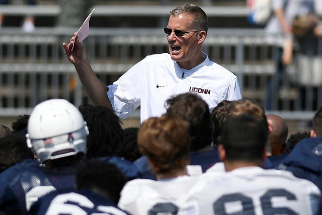 FILE - In this April 14, 2018, file photo, head coach Randy Edsall talks with his team at the end of Connecticut's annual spring NCAA college football game in East Hartford, Conn. UConn will host Central Florida to open the regular season on Thursday, Aug. 30. (AP Photo/Jessica Hill)