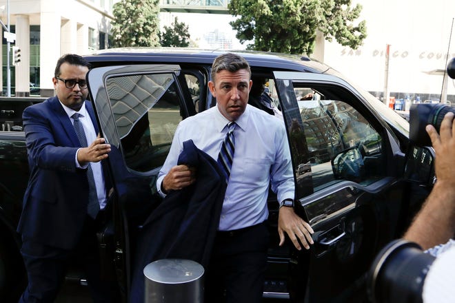 U.S. Rep. Duncan Hunter, center, arrives for an arraignment hearing Thursday, Aug. 23, 2018, in San Diego. Hunter and his wife were indicted Tuesday on federal charges that they used more than $250,000 in campaign funds for personal expenses that ranged from groceries to golf trips and lied about it in federal filings, prosecutors said.