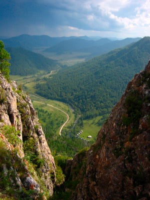 This undated photo provided by Bence Viola of the University of Toronto in August 2018 shows the valley above a cave where Denisovan fossils were found in the Altai Krai area of Russia. On Wednesday, Aug. 22, 2018, scientists reported in the journal Nature that they have found the remains of an ancient female whose mother was a Neanderthal and whose father belonged to another extinct group of human relatives known as Denisovans.