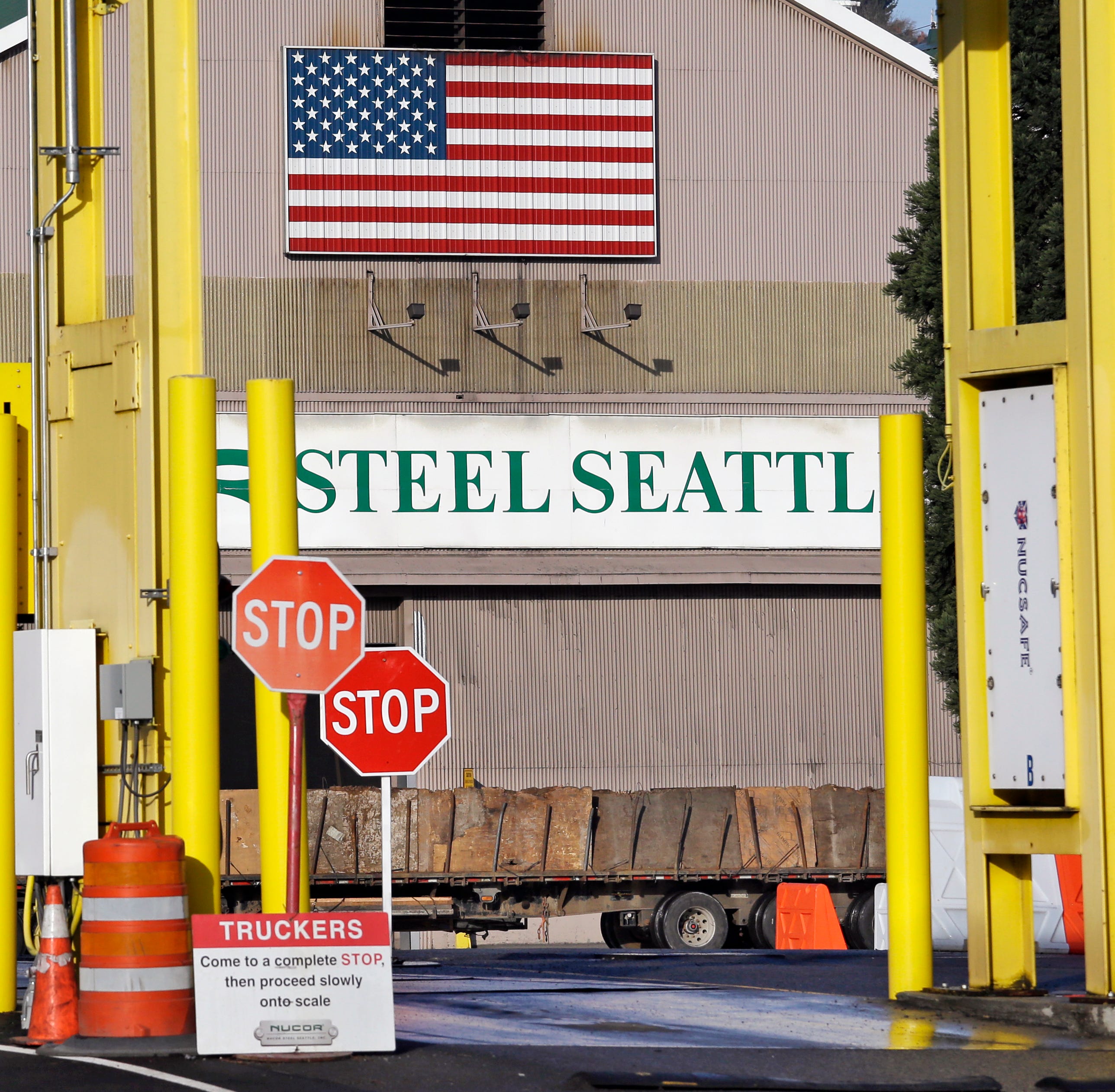 In this Feb. 25, 2016 file photo, a truck carries a load at the Nucor Steel plant in Seattle. U.S. companies pursuing exemptions from President Donald Trump's tariff on imported steel are accusing American steel manufacturers of spreading inaccurate 