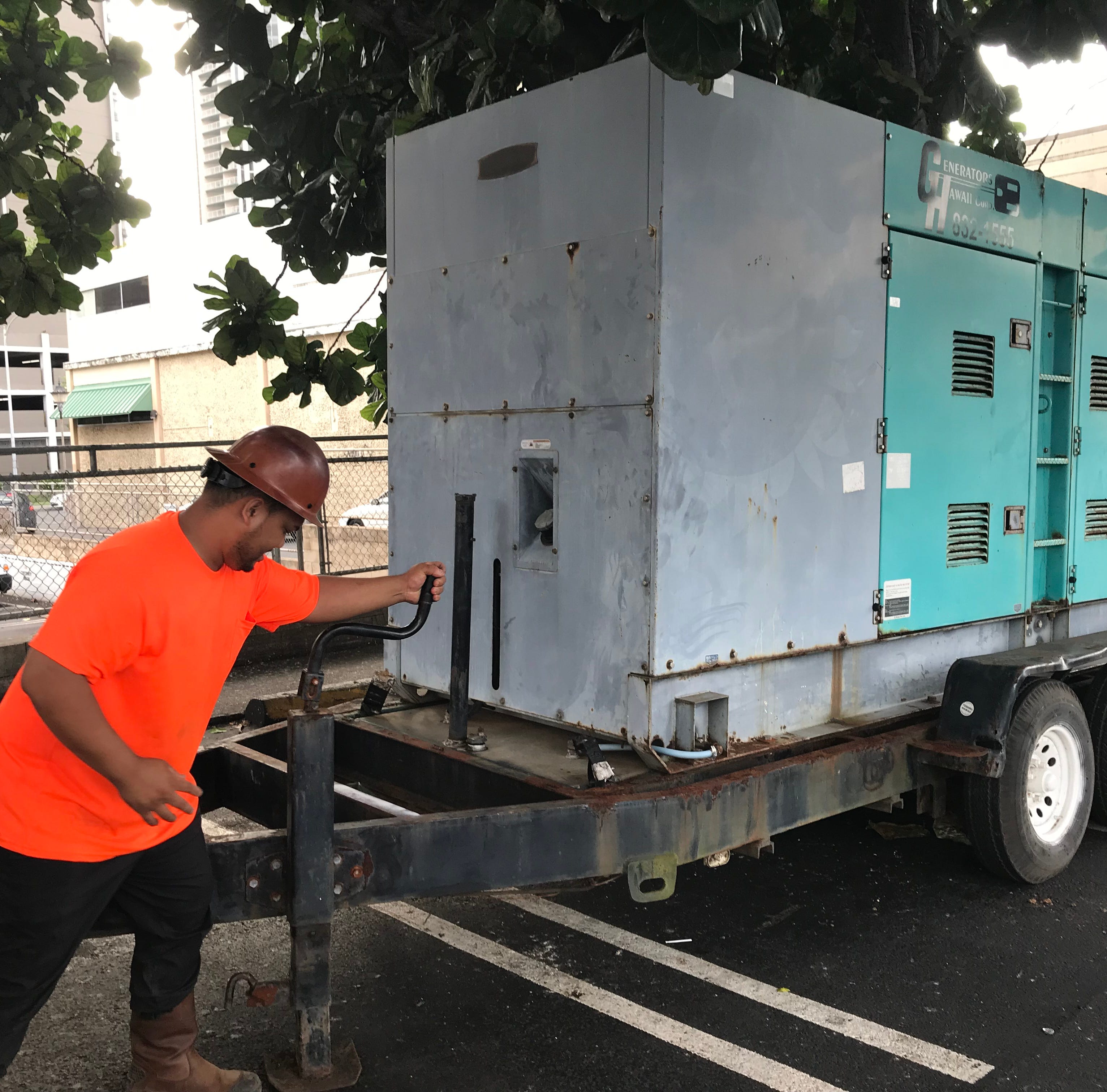 Justin Pagba installed a generator in the parking lot of a Longs Drugs in Honolulu in case Hurricane Lane knocks power out to the state capitol.