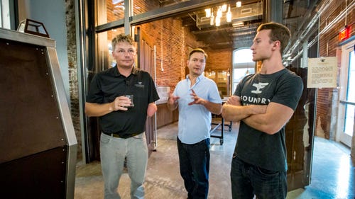 Scott Bush, Founder, Foundry Distilling Co., left, with distillers Cory O'Neel, center, and Greg Biagi, right, during a tour of their new facility and distillery Friday, Aug. 24, 2018, in West Des Moines.