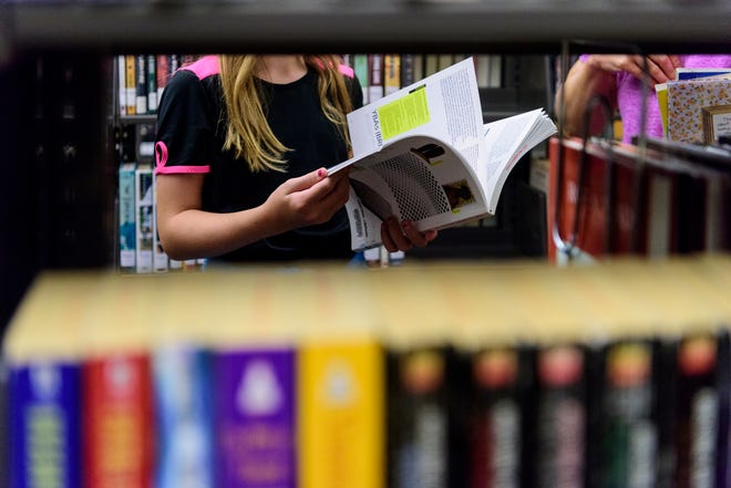 A library user browses shelves at the Evansville Vanderburgh Central Library in downtown Evansville.