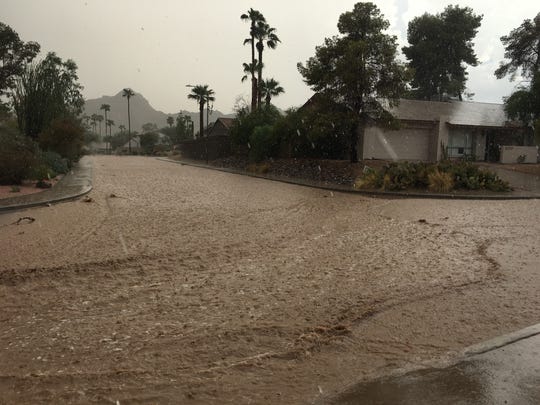 Streets flood near 24th Street and Shea Boulevard in Phoenix during a monsoon storm.