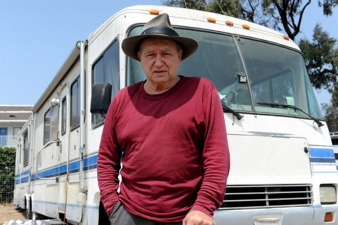 Charlie Creel stands outside his RV, in which he lives, behind Motel 6 near the Salinas airport.