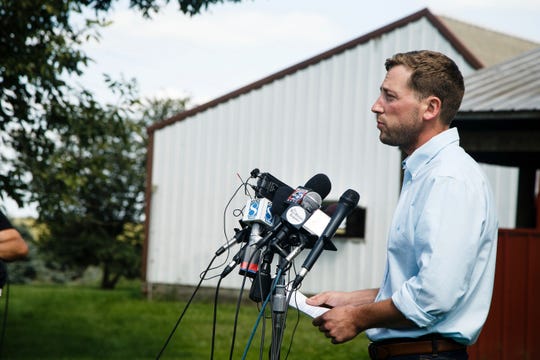 Dane Lang, co-owner of Yarrabee Farms, speaks to the press with his father and co-owner Craig Lang, on their family's farm on August 22, 2018, in Brooklyn, Iowa. Cristhian Rivera, a former employee at the farm, has been charged with the murder of Mollie Tibbetts.