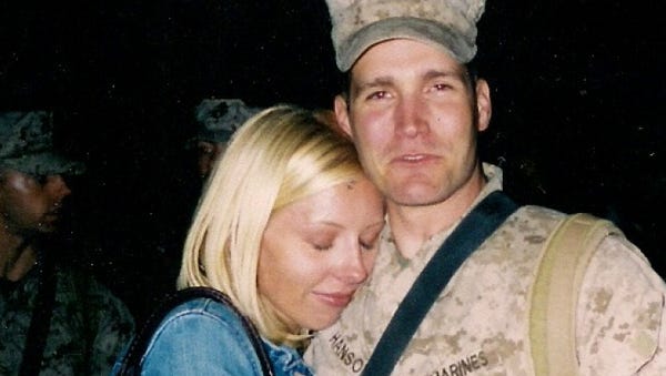 J.J. Hanson hugs his wife, Kristen, upon his...