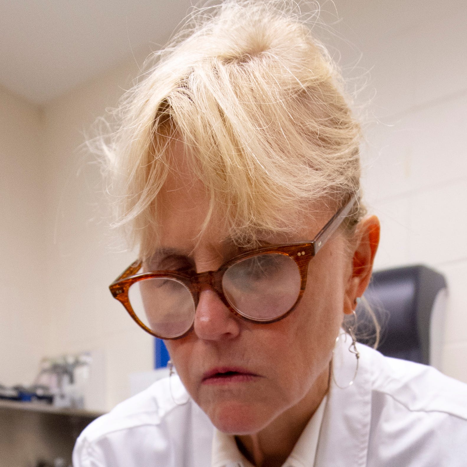 Ann C. McKee examines a brain at the VA-Boston University-Concussion Legacy Foundation Brain Bank earlier this month.