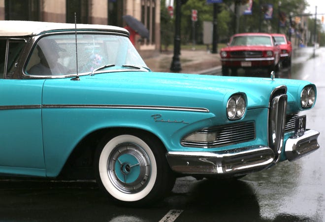 A Ford Edsel pulls out in the rain during the Heart of the City Cruise on Saturday. 