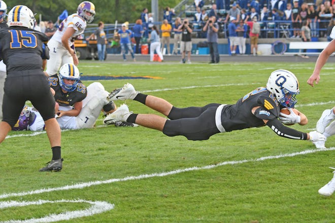 Warrior's Easton Clifton dives for a first down during a game with Lexington High School at Ontario High School.