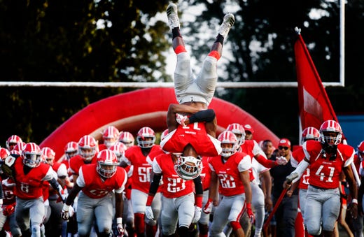 Germantown's Kendal Badgett does a flip while taking the field against Houston before their prep football game in Germantown.