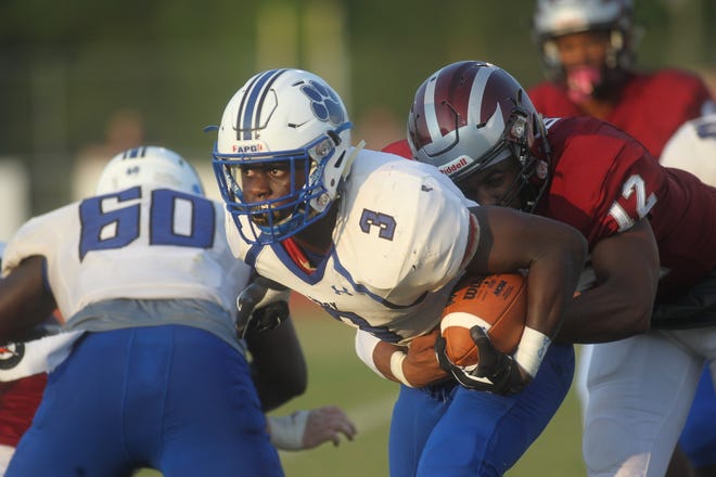 Godby running back Jaquez Yant looks for yardage as Chiles' Erique Dickey tries to bring him down during a Week 1 game.