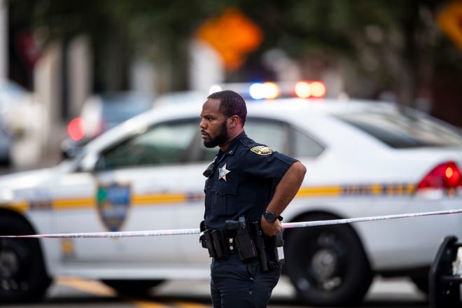 A police officer stands by where an active shooter was reported Sunday, Aug. 26, 2017 in Jacksonville, Fla. after a gunman opened fire Sunday during an online video game tournament that was being livestreamed from a Florida mall, killing multiple people and sending many others to hospitals. (AP Photo/Laura Heald)