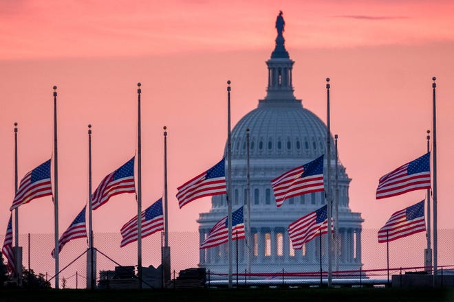 Flags flying a half-staff in honor of Sen. John McCain, R-Ariz., frame the U.S. Capital at daybreak in Washington, Sunday, Aug. 26, 2018. McCain, 81, died at his ranch in Arizona after a yearlong battle with brain cancer.