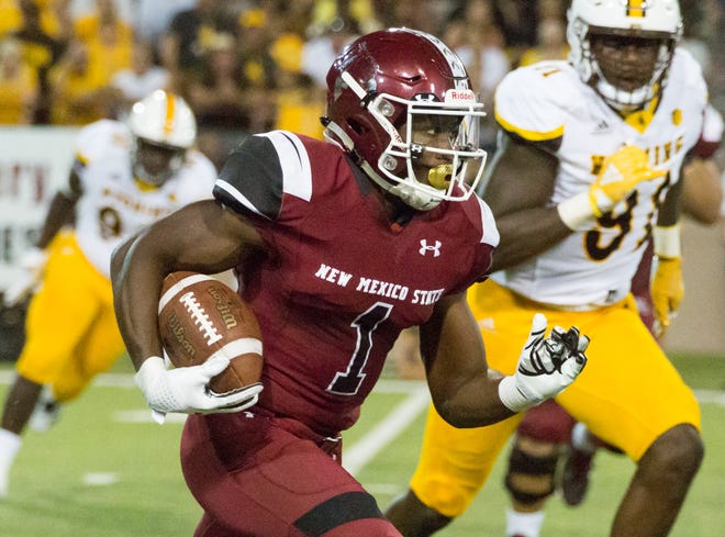 NMSU running back Jason Huntley looks for yards on Saturday, August 25, 2018 as the Aggies take on Wyoming at Aggie Memorial Stadium.