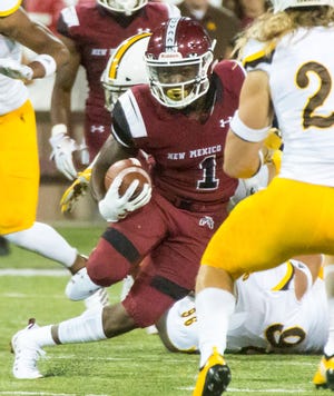 NMSU running back Jason Huntley looks for yards on Saturday, August 25, 2018 as the Aggies take on Wyoming at Aggie Memorial Stadium.