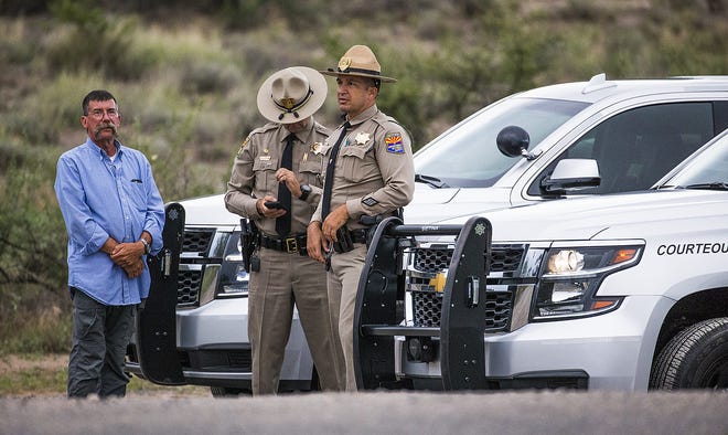 DPS troopers stand at the roadblock on Hidden Valley Road at the intersection of North Page Springs Road in Cornville on Aug. 25, 2018.  The road leads to the compound where Sen. john McCain died Saturday.