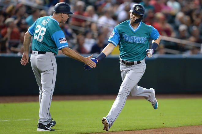 Aug 25, 2018; Phoenix, AZ, USA; Seattle Mariners right fielder Mitch Haniger (17) slaps hands with Seattle Mariners third base coach Scott Brosius (28) after hitting a solo home run against the Arizona Diamondbacks during the first inning at Chase Field. Mandatory Credit: Joe Camporeale-USA TODAY Sports