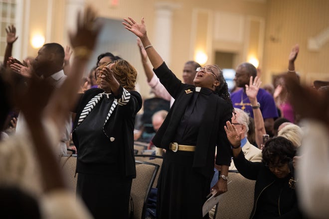 Churchgoers worship during a sermon by Rev. Christopher T. Curry during the 205th August Quarterly Worship Service Sunday at the Chase Center. 