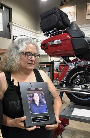 Brenda Wilson shed a tear on a photo of her daughter at the Harley-Davidson dealership where the 29-year-old worked.