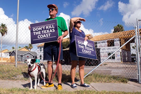 Lola, Robert and Patricia Branch and their dog, Lola, stand outside an apartment complex being rebuilt after being damaged by Hurricane Harvey in Aransas Pass. The couple own a home and business and commercial property in Aransas Pass and joined other homeowners, business owners and elected officials from throughout the Coastal Bend in protesting windstorm insurance rate increases on Monday, August 27, 2018. 