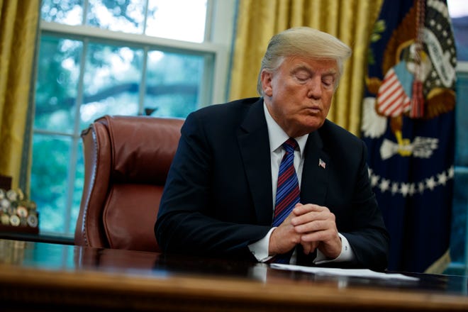 President Donald Trump talks on the phone with Mexican President Enrique Pena Nieto, in the Oval Office of the White House, Monday, Aug. 27, 2018, in Washington. Trump is announcing a trade "understanding" with Mexico that could lead to an overhaul of the North American Free Trade Agreement. Trump made the announcement Monday in the Oval Office, with Mexican President Enrique Pena Nieto joining by speakerphone.  (AP Photo/Evan Vucci)