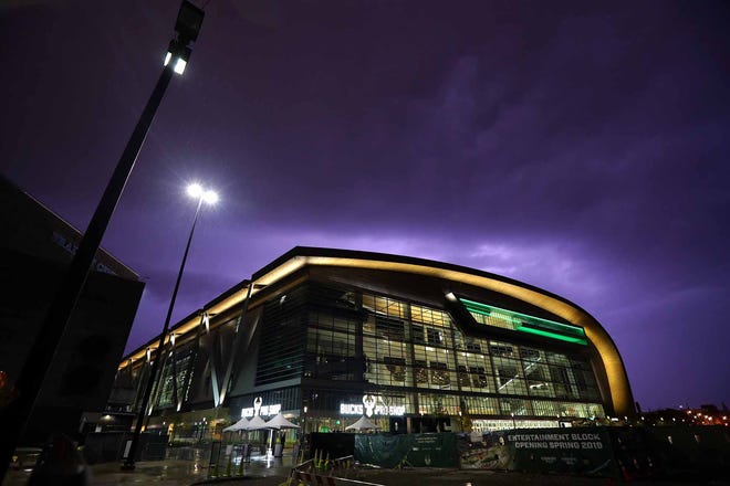 Lightning flashes above the Fiserv Forum, the new home of the Milwaukee Bucks on Sunday evening. The storms held off long enough, as earlier in the day the public got their first look at the new arena on Sunday
