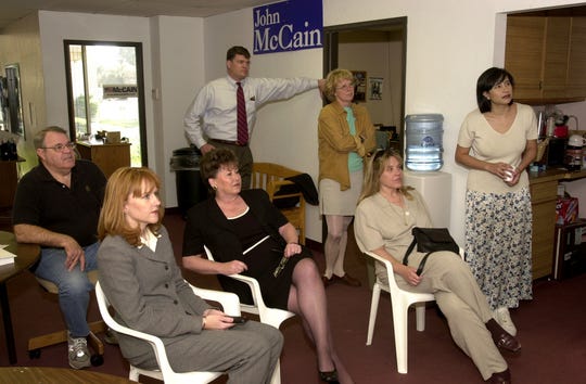 John Tyler (from left), Kirstin Tully, Babs Donaldson, Larry Pike (standing), Deb Gullett (standing), Deb Jacobus and Bettina Nava watch a TV broadcast at McCain headquarters as the senator announces the end of his campaign for president in March 2000.
Russell Gates photo. 3/9/2000