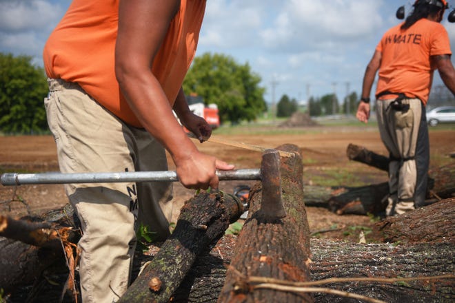 Inmates chop wood at the South Dakota State Penitentiary Friday, Aug 17, in Sioux Falls. Mary Montoya, South Dakota State Penitentiary Chapel volunteer, said they are experiencing a shortage of donated wood. It is becoming problematic for inmates who participate in sweat lodge ceremonies.