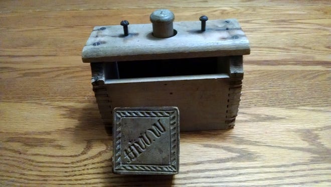 Author Jerry Apps' grandfather used this little wooden box along with the design block to prepare butter for sale.