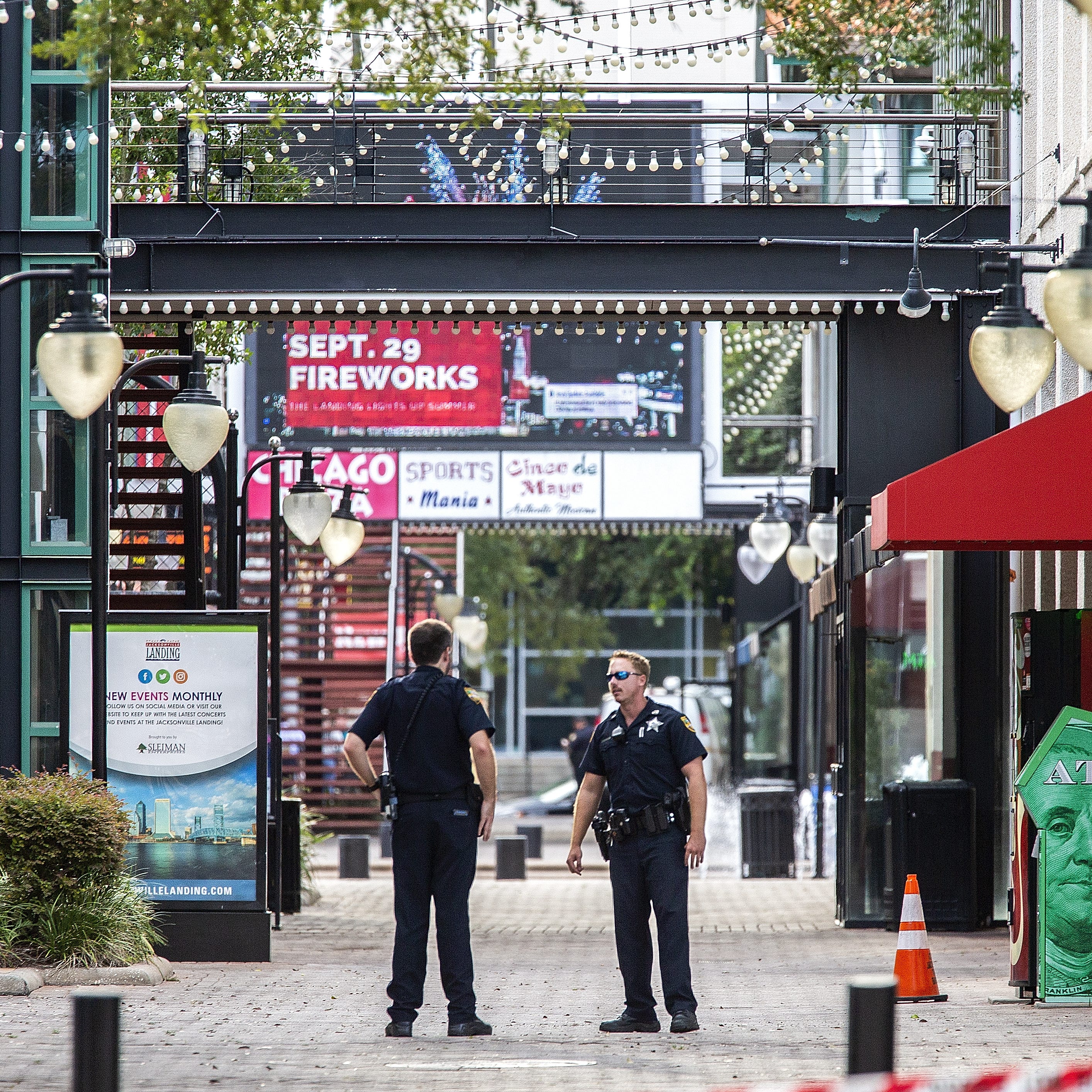 JACKSONVILLE, FL - AUGUST 26:  Jacksonville Sheriff's officers patrol around the ships at Jacksonville Landing on August 26, 2018 in Jacksonville, Florida. A shooting rampage during a Madden 19 video game tournament at the site claimed four lives, wi
