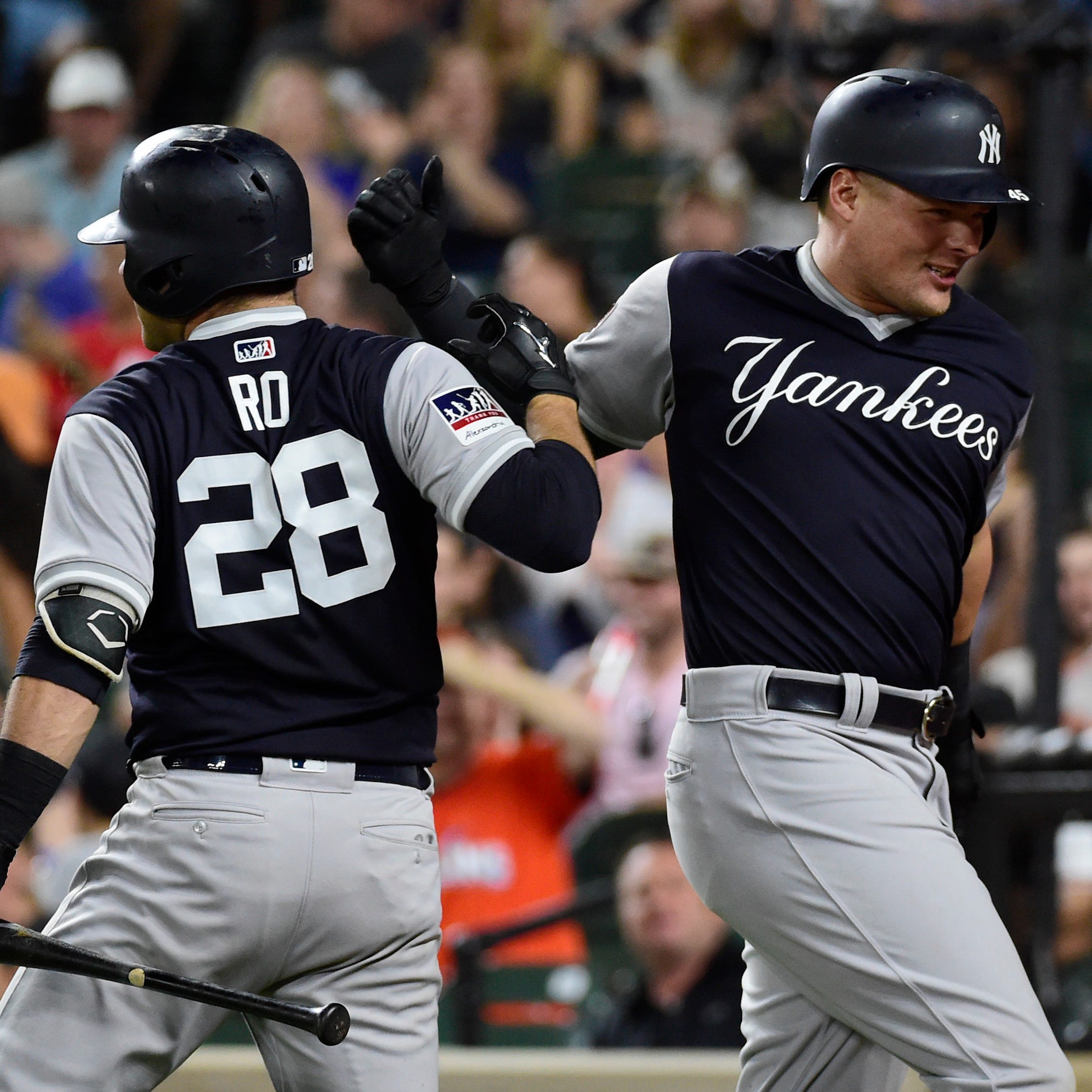 The Yankees' Luke Voit (right) celebrates Austin Romine after hitting a two-run home run against the Orioles.