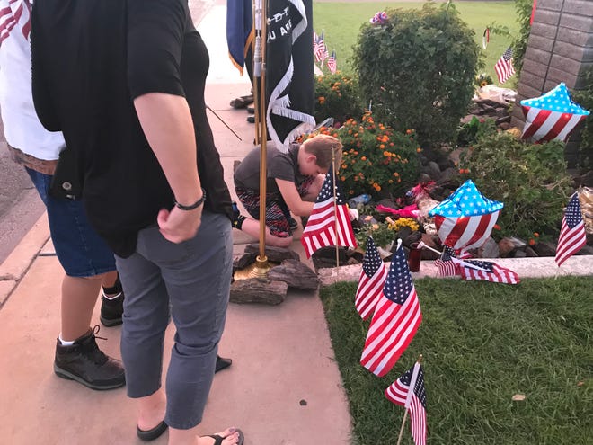 Boy pays respects to McCain by setting flag down at Phoenix Mortuary.