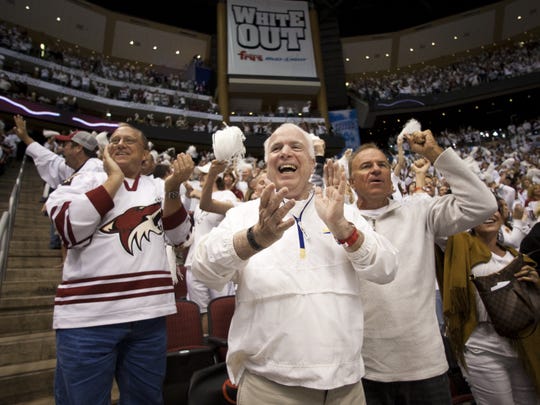 Sen. John McCain (center) celebrates a goal by Shane Doan during the 2012 NHL playoffs at Jobing.com Arena.