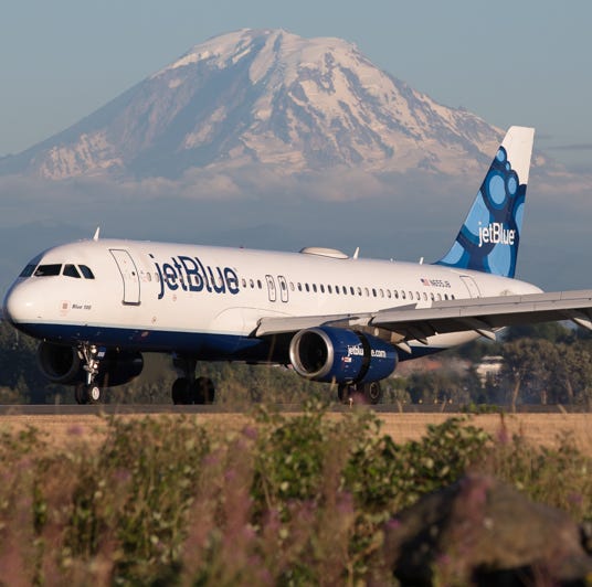 A jetBlue Airbus A320 lands at Seattle-Tacoma International Airport in July 2017.