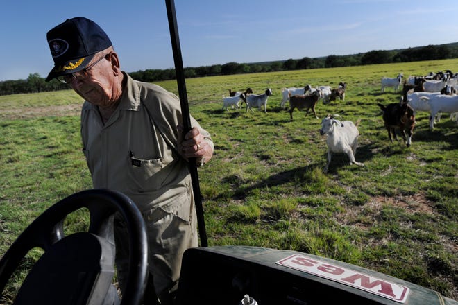 Wes Hays steps into his golf cart after checking on his goats at his Novice ranch Friday May 26, 2011. Hays was awarded the Navy Cross for his service as a naval aviator during World War II.