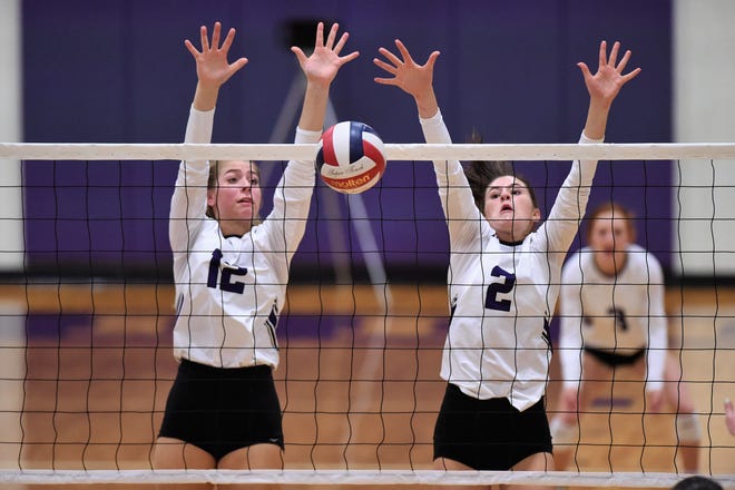 Wylie's Madison Burden (12) and Avery Wimberly (2) reach for a block during the Lady Bulldogs' match against Brock at Bulldog Gym on Tuesday, Aug. 28, 2018. The Lady Bulldogs won 3-1.