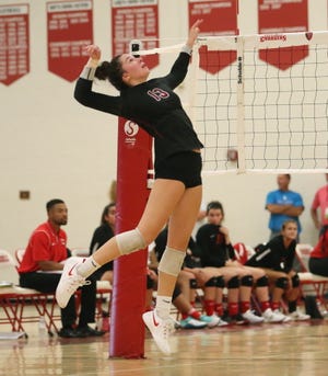 Churchill junior outside hitter Sarah Dunn goes up for the kill in Tuesday's three-set win over Canton.