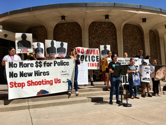 Demonstrators gather Wednesday, Aug. 29, 2018, outside Phoenix City Council Chambers to bring attention to the number of police shootings in Phoenix this year.