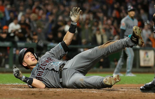 Arizona Diamondbacks' Nick Ahmed tumbles and waits for the call after being thrown out at home plate in the eighth inning of a baseball game against the San Francisco Giants, Tuesday, Aug. 28, 2018, in San Francisco. (AP Photo/Eric Risberg)