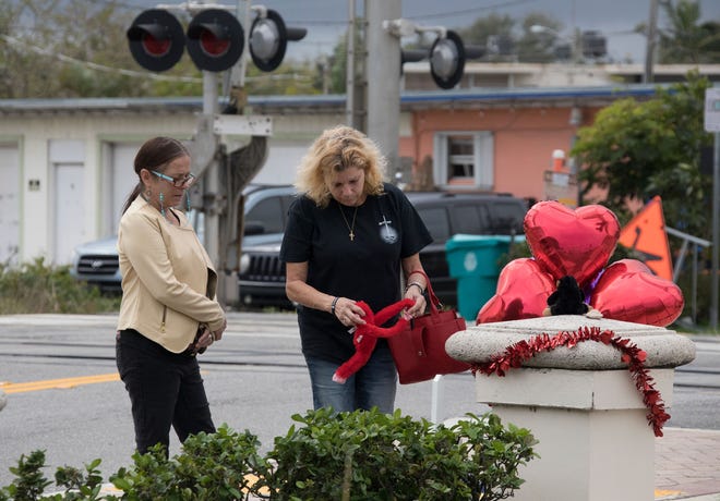 Debbie King (right) and her friend Tricia Woodland visit a memorial for King’s brother Jeffrey King on Sunday, Jan. 21, 2018, at the railroad crossing for the Brightline train on East Ocean Avenue in Boynton Beach. Jeffrey King was hit and killed by a Brightline Train on Wednesday, Jan. 17, while riding his bicycle across the tracks at East Ocean Avenue and Northeast Fourth Street in Boynton Beach.