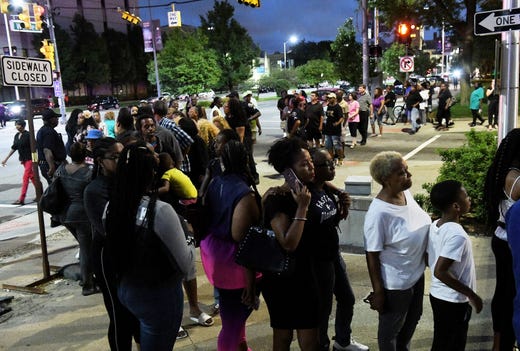People near the end of the line at the corner of Warren Avenue and John R. Street outside the Charles H. Wright Museum of African American History. Kourney Graham has her arm around her daughter, Journee Sherman, 11, both of Oak Park, in foreground. The line wrapped around from Warren Avenue, north on Brush to Frederick Street, then south on John R. Street back to Warren Avenue.
