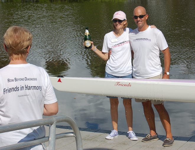 Lin Reading, Friends After Diagnosis founder and facilitator, and Vero Beach Rowing Director Austin Work at the christening of the new rowing shell, "Friends."
