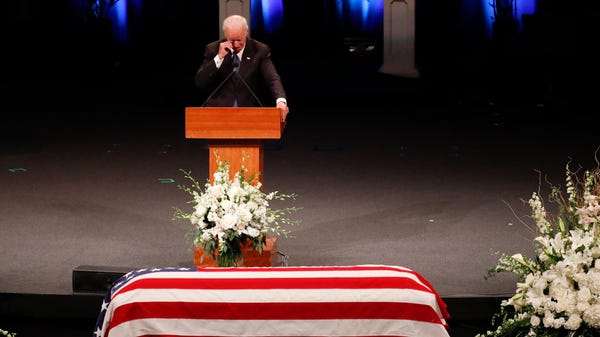 Former Vice President Joe Biden wipes a tear while giving a tribute during a memorial service or Sen. John McCain at North Phoenix Baptist Church in Phoenix, Aug. 30, 2018. 