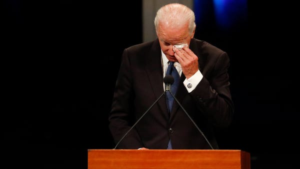 Former Vice President Joe Biden wipes a tear...