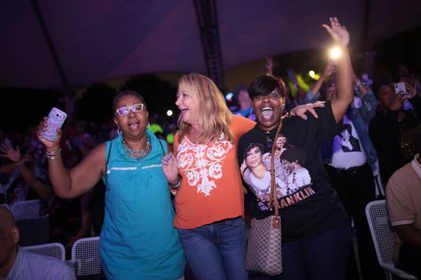 People dance to a performer during an Aretha Franklin tribute concert at Chene Park Amphitheatre in Detroit on Thursday, August 30, 2018.